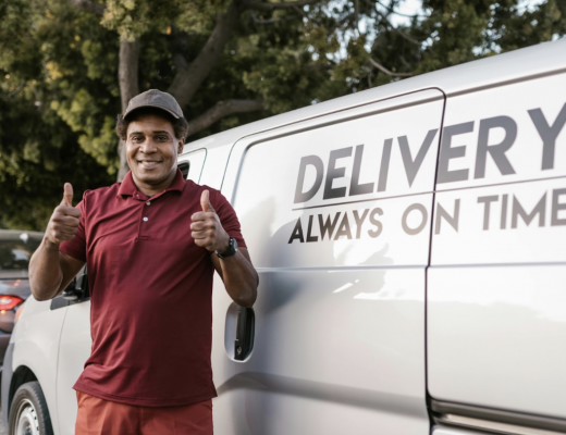 Smiling Delivery Driver Standing in Front of a Van